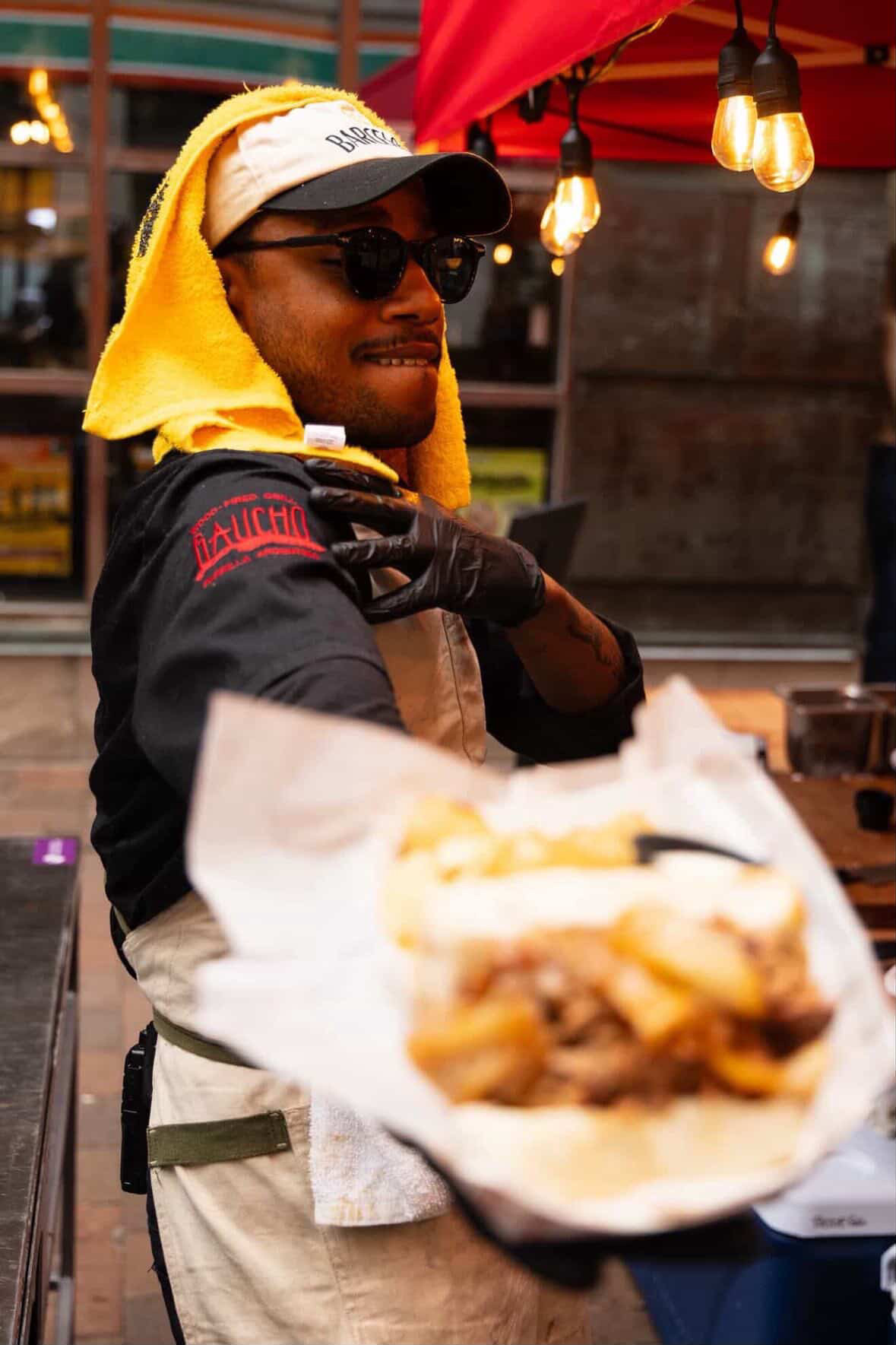 Chef Darrel beside a live-fire service setup